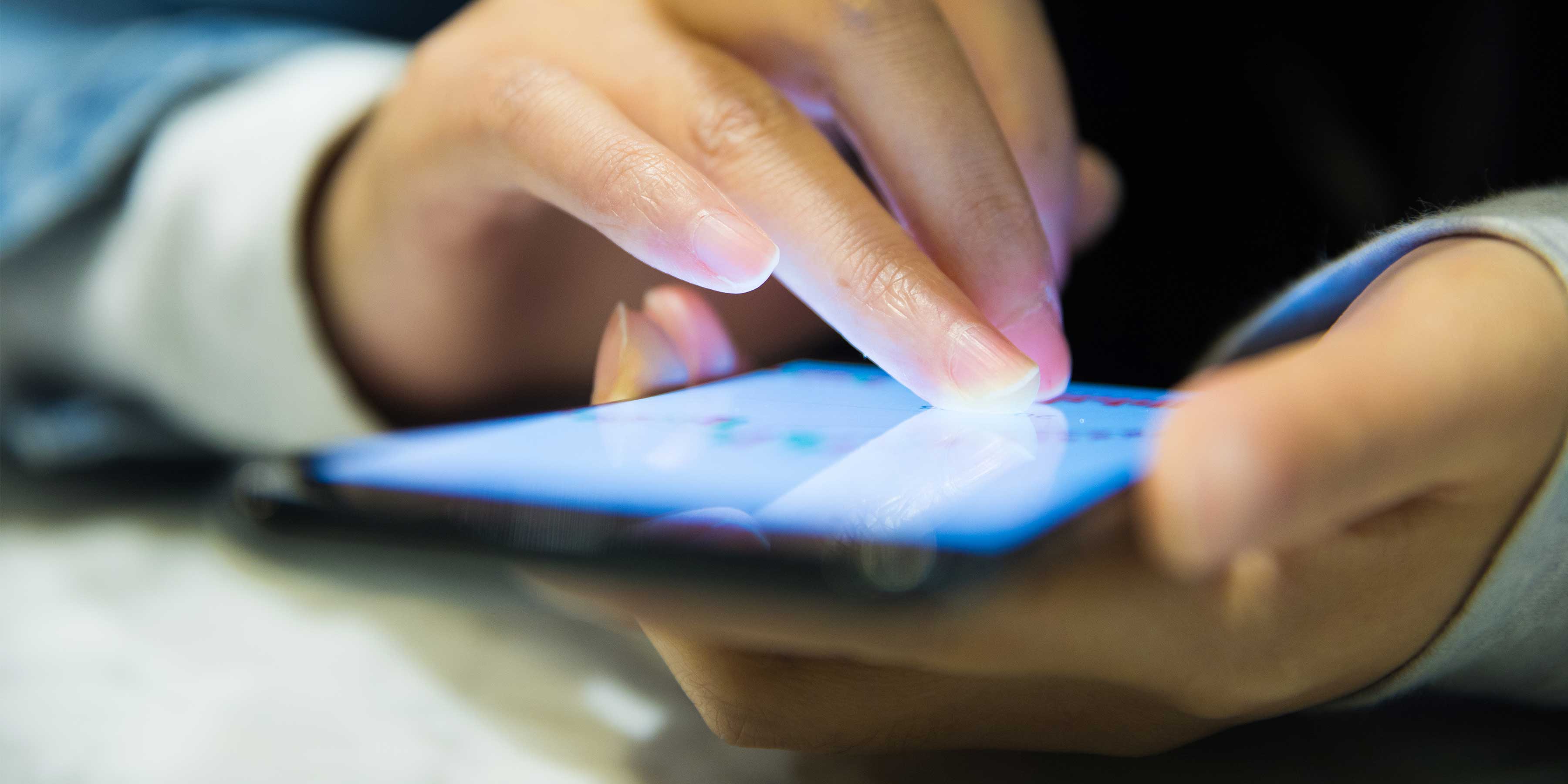 Close up of hands using a mobile phone