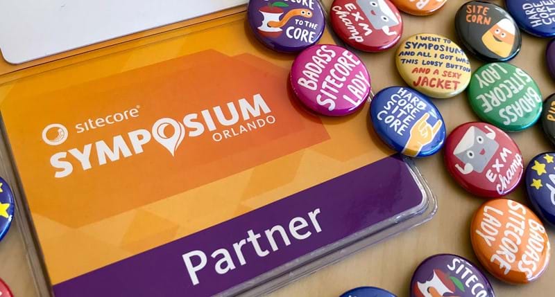 Symposium badge surrounded by colorful buttons