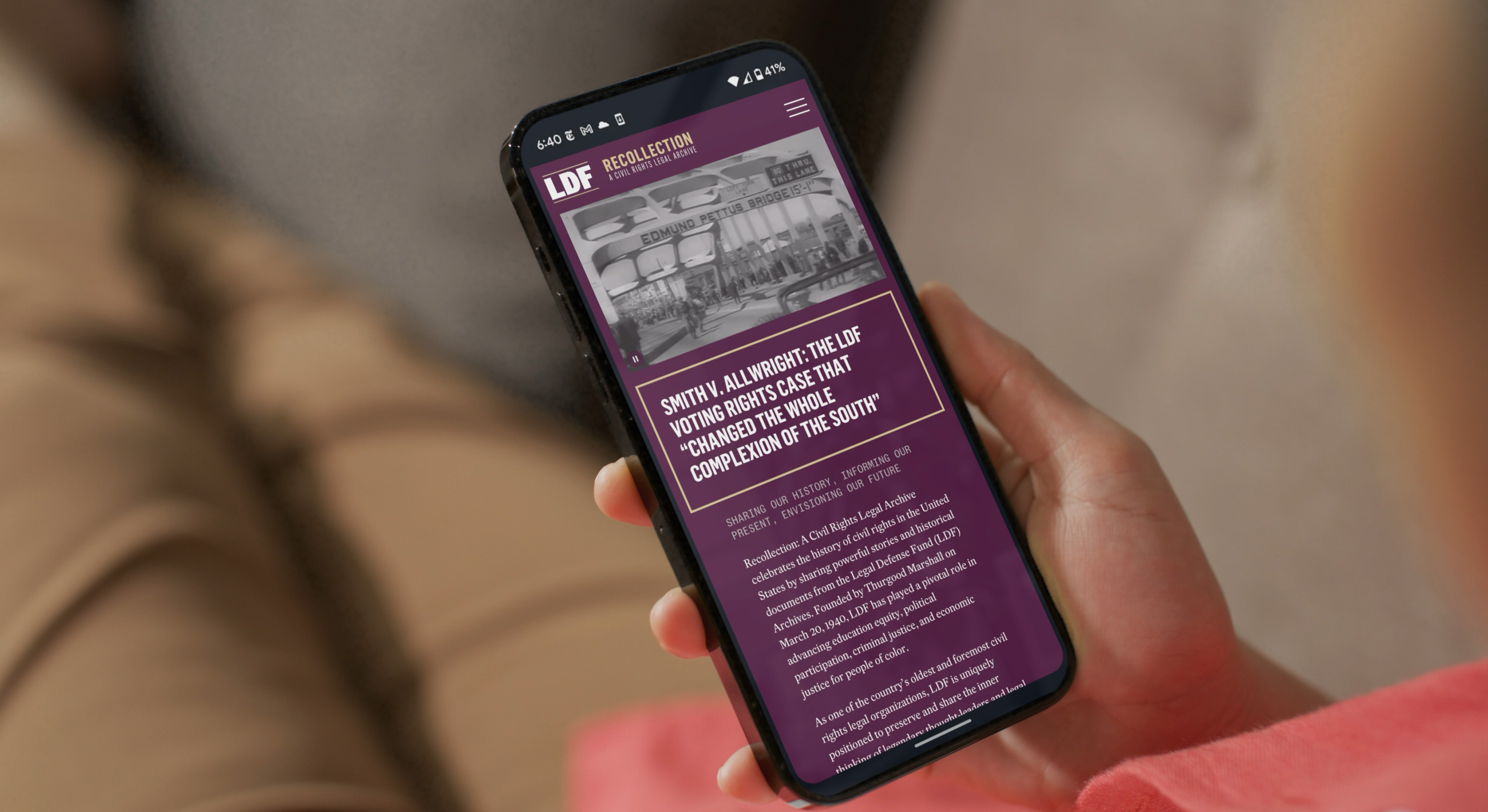 Hand holding mobile phone displaying the LDF Recollection website